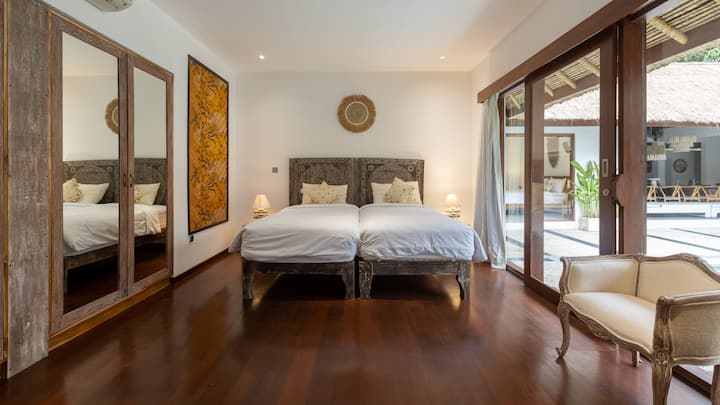 Bedroom 6 — Part of the Family Bungalow, shared with Bedroom 7. This room has 1 King-size bed and 2 single beds. Bedroom 7 features 1 King-size bed. Both rooms share a private bathroom. Ideal for families or groups travelling together.