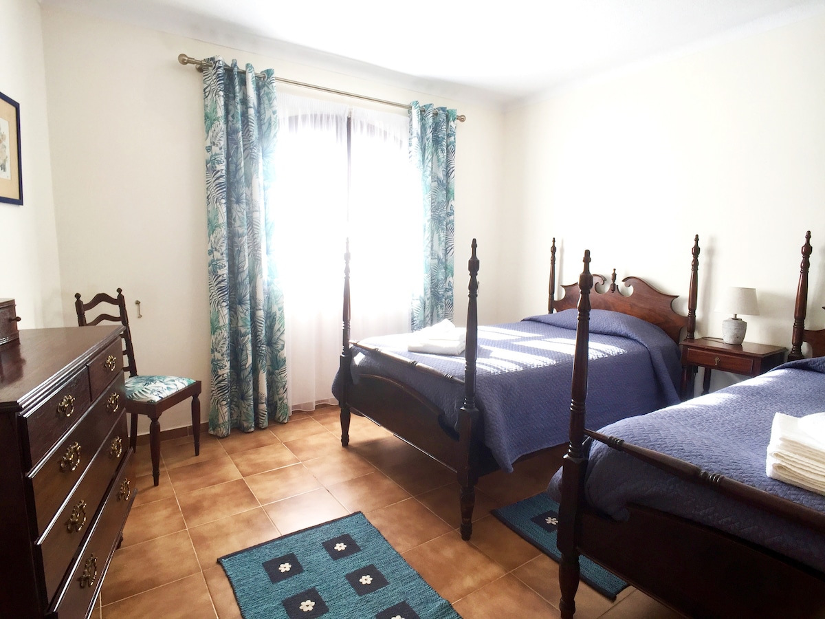 Пространа спална соба со два кревета