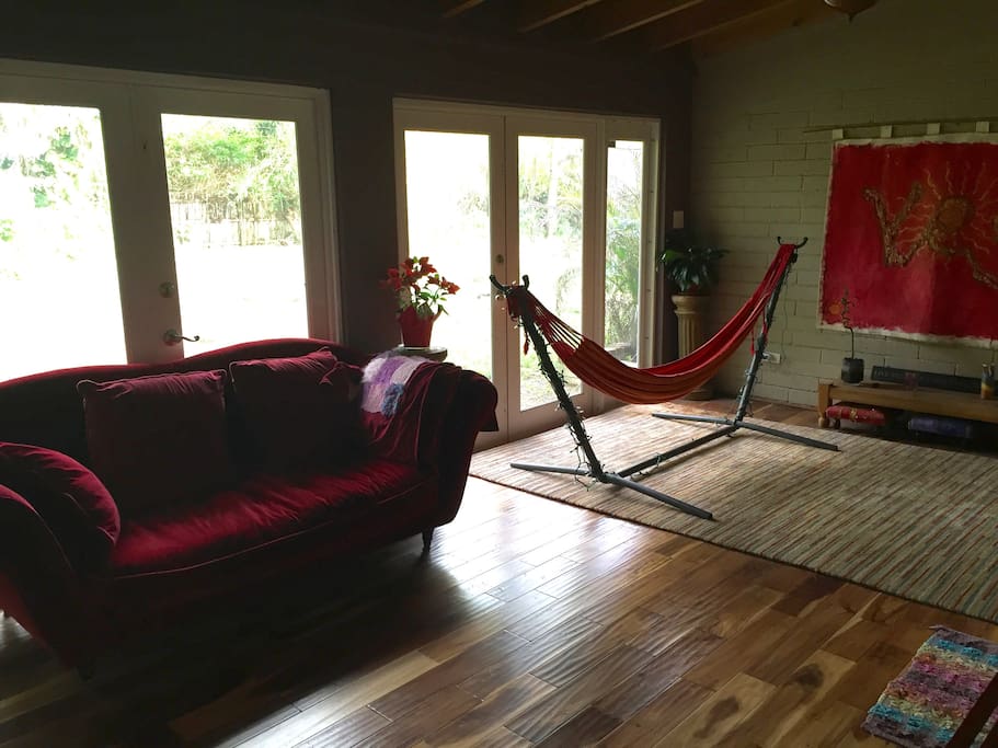 Peaceful entryway and hangout spot, with burgundy velvet couch and indoor hammock. Great place to read, chat, nap or meditate. :-)
