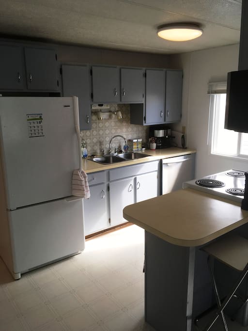 Kitchen has coffee maker, kettle, toaster oven, George foreman grill, dishes, glassware, pots and pans, etc...