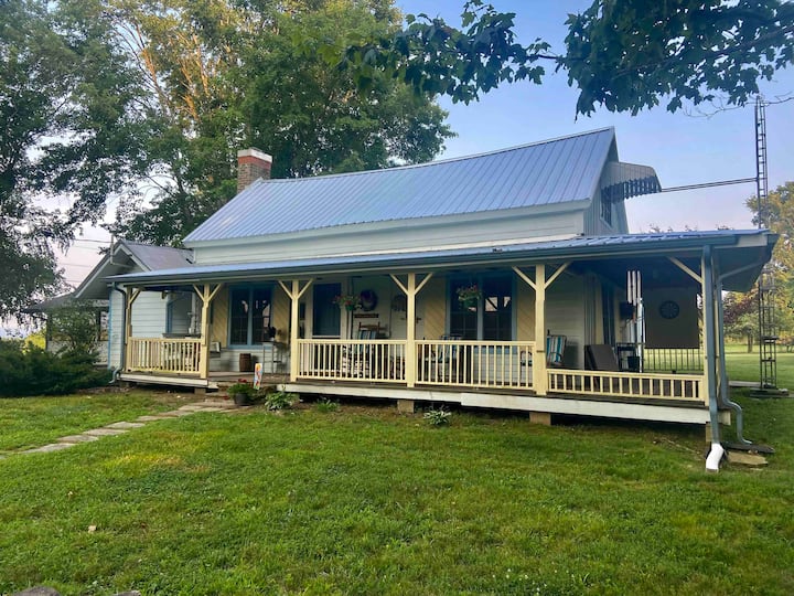 acadian style house with wrap around porch