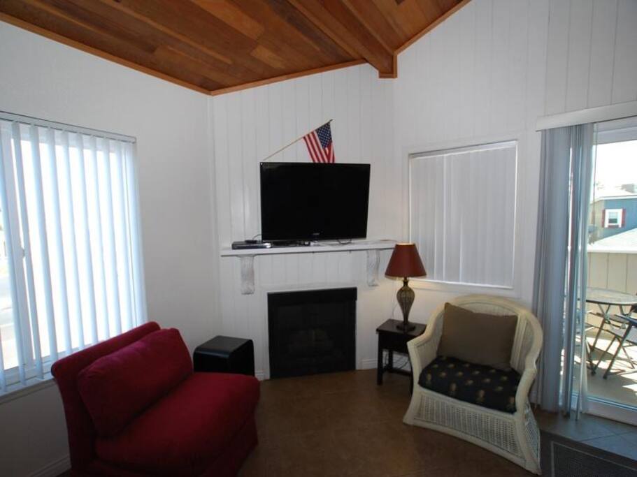 Fireplace in living room with flat panel TV mounted above the fireplace.
