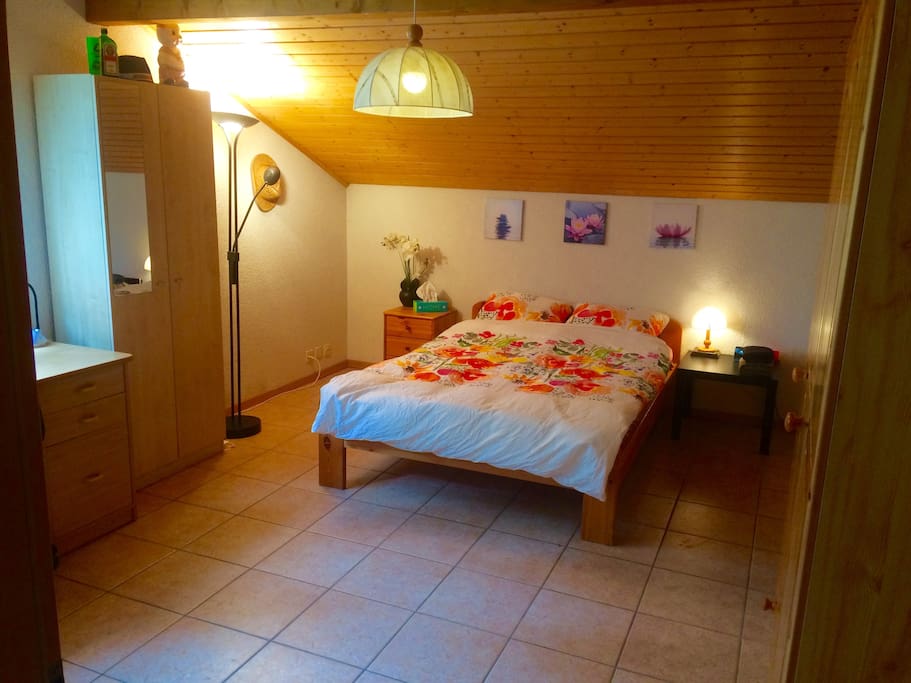 Top floor bedroom with queen bed and desk space