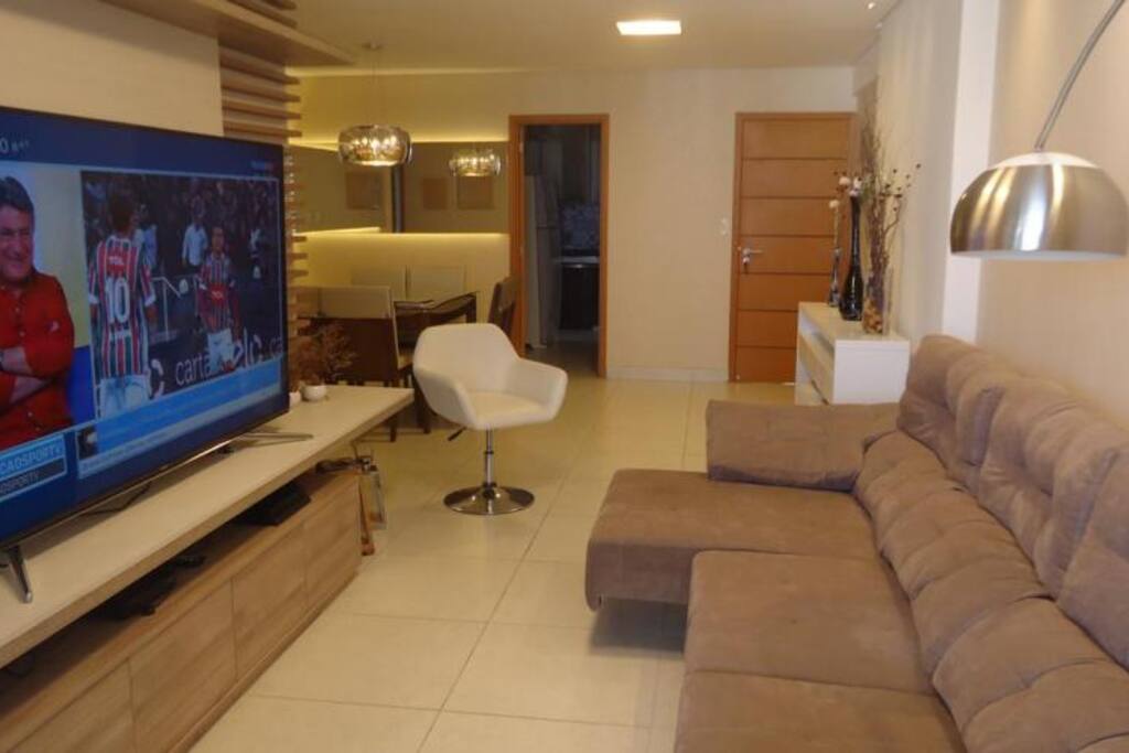Living room with a 75 inch TV and a large retractable couch