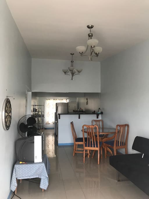 The living area with dining area beyond it. The sofa is a sofa bed sleeping 2 people.