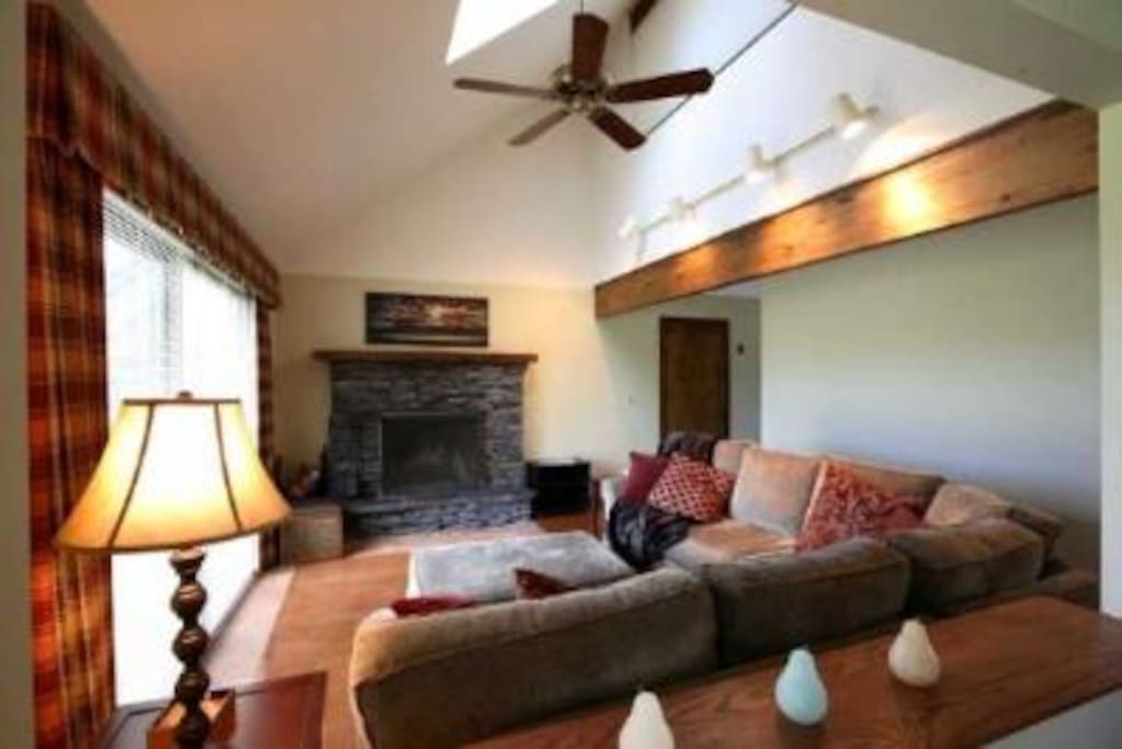 Relax by the fire on the large, comfy couch