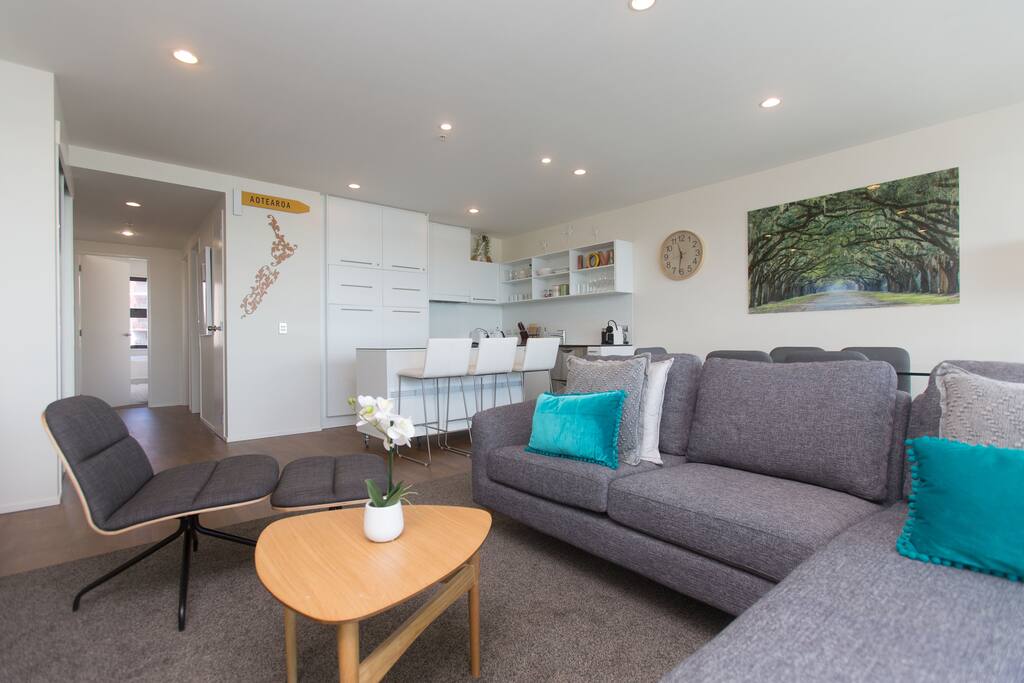 Nice comfortable sofa and a single swivel chair with foot stool