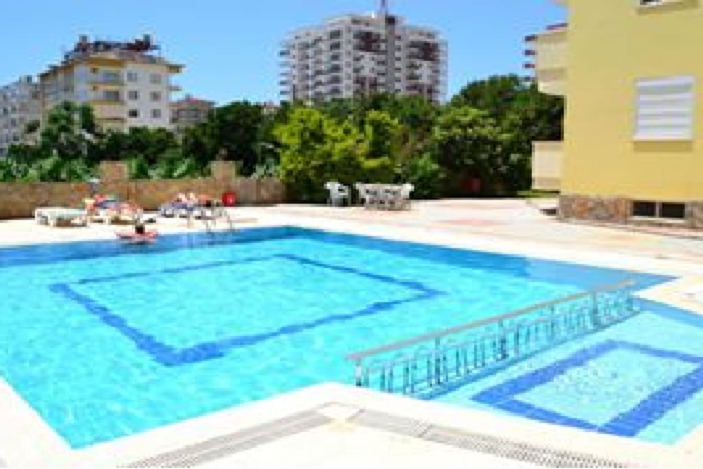 Private swimming pool, safe for children located at back of apartment block.
