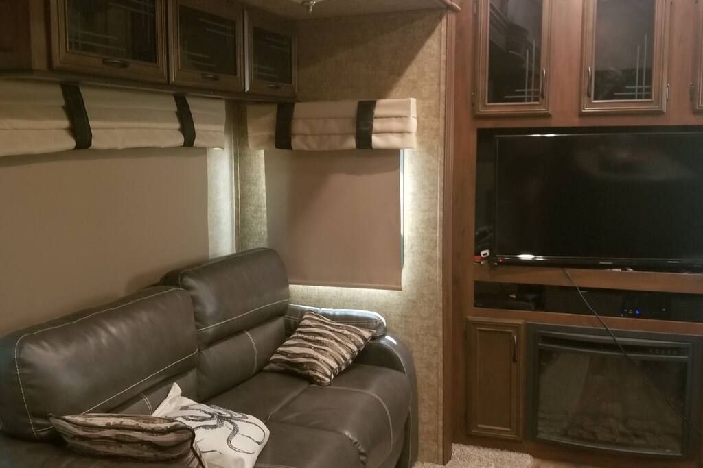 Living Room with Couch (turns into a bed), TV, and Electric Fireplace