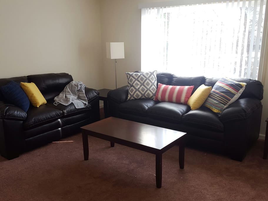 The overstuffed faux leather sofa and love-seat provide ample seating - and napping - space!
