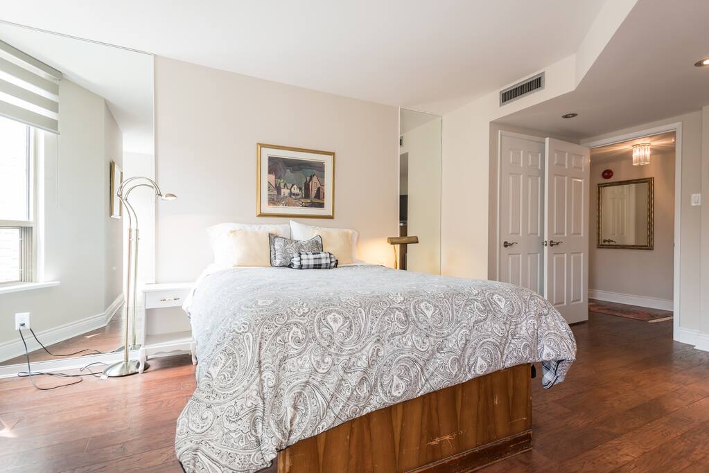 Another view of the guest room looking out into the hallway and bathroom. South facing 2 large windows overlooking historic buildings.