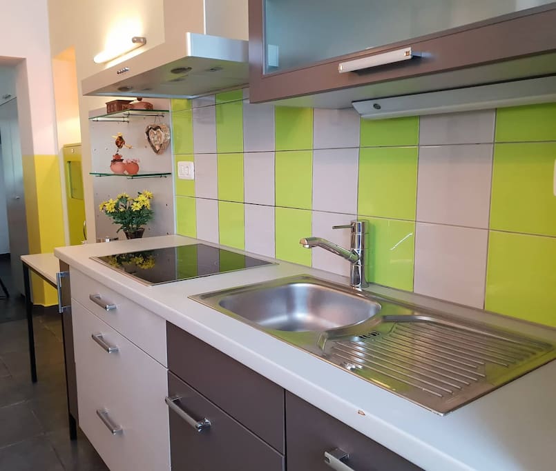 Full kitchen with coffee, tea and fridge.