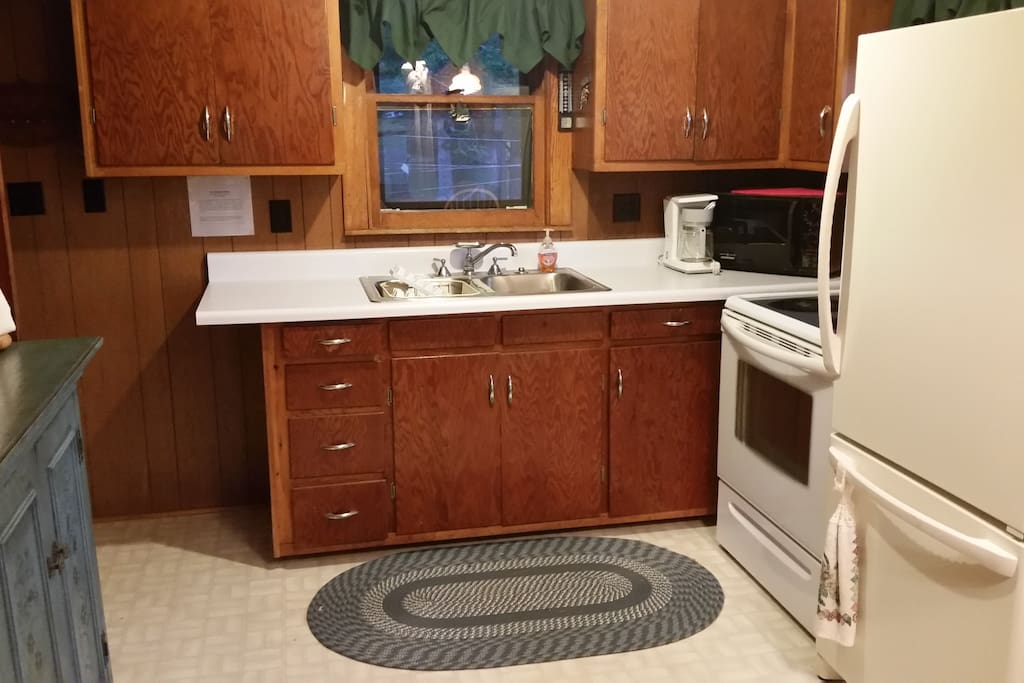 Kitchen view, which includes sink, microwave, coffeemaker, stove/oven and refrigerator.