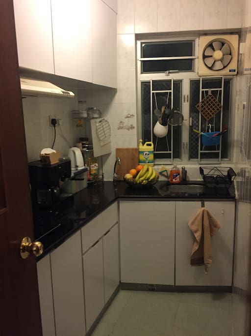Fully functional kitchen with refrigerator and stove.