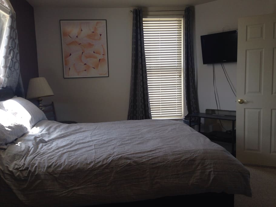 Queen size bed with basic TV/DVD player in the bedroom.