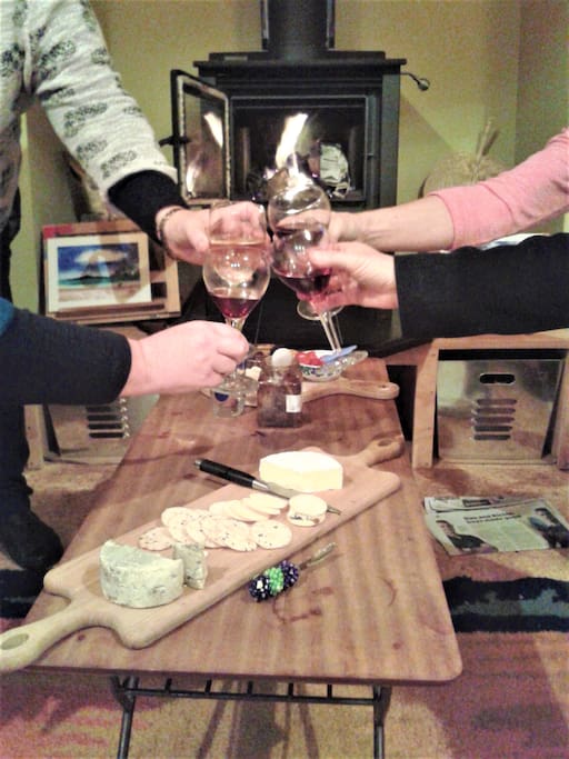 Enjoying wine and nibbles by the fire