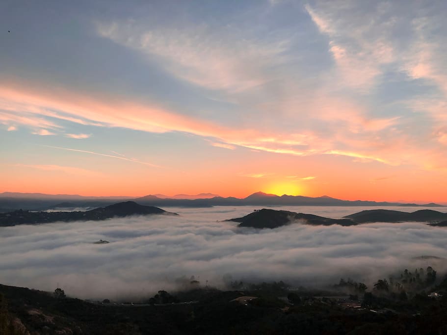 On the deck at sunrise above the clouds enjoying morning coffee.