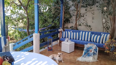A Cretan house in a garden, overlooking the sea