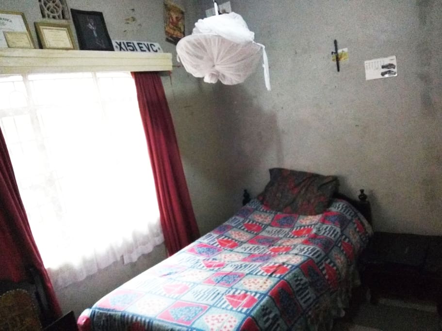 spacious bedroom with mosquito net