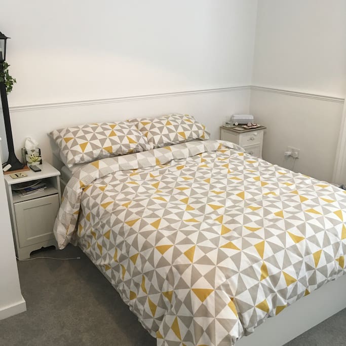 Comfortable double bed in spacious bedroom