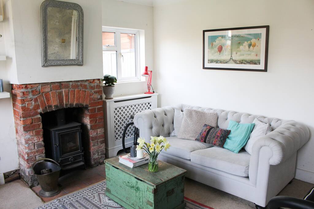 Living room with log burner, sofa and armchair