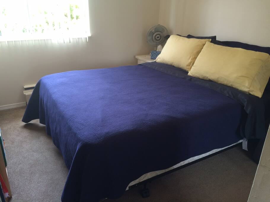 Spacious queen bed and fan for comfort.