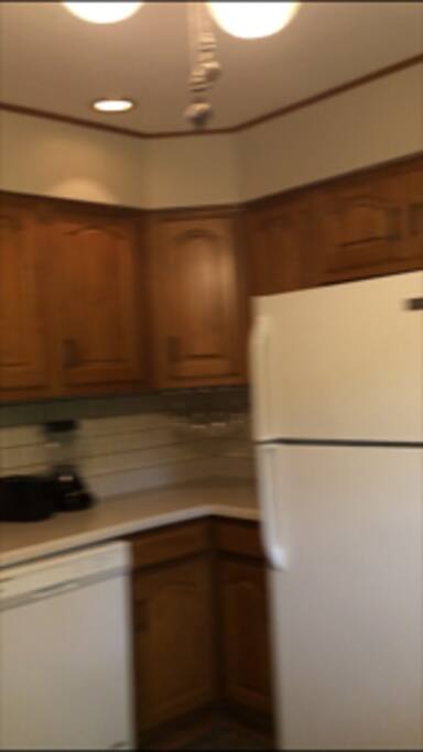 Kitchen stocked with dishes and cookware.