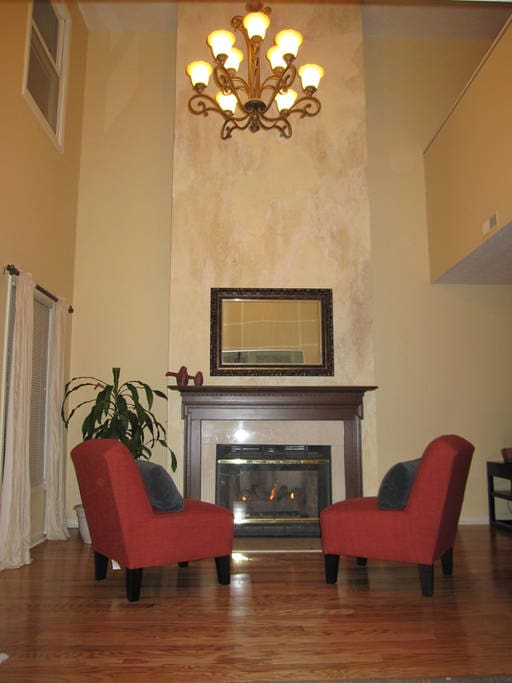 Entrance way with fireplace and chandelier