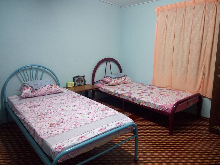 One of the rooms. Equipped with two Single size beds, hangers and spacious room.