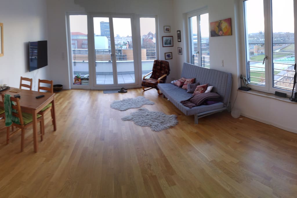 Great and spacious living room with large windows facing the park and city