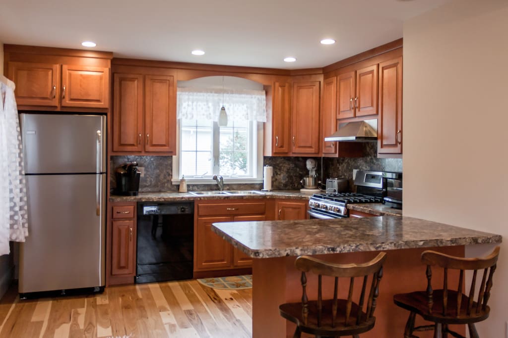 The updated kitchen features cherry cabinets and plenty of prep space on the counters.