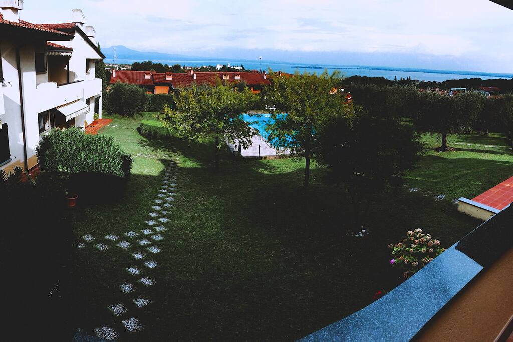 Balcony view (Back garden + swimming pool + Lake)