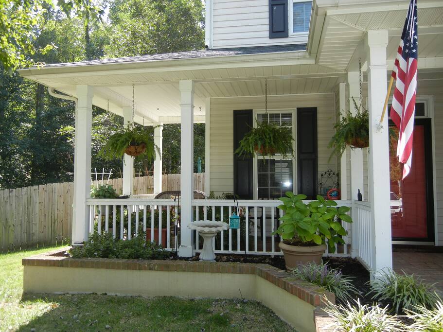 Shady front porch perfect for reading with a glass of wine.