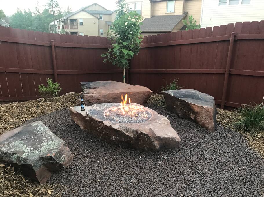 Boulder fire pit in backyard