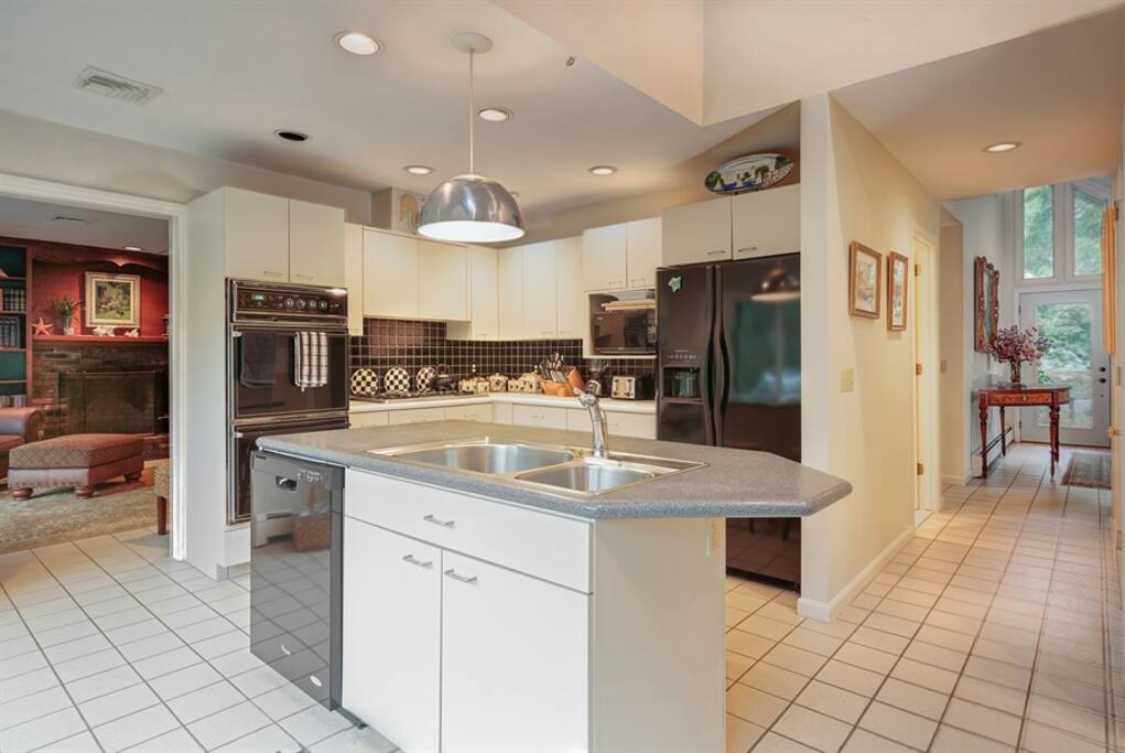 open kitchen with french doors overlooking large decks and gardens