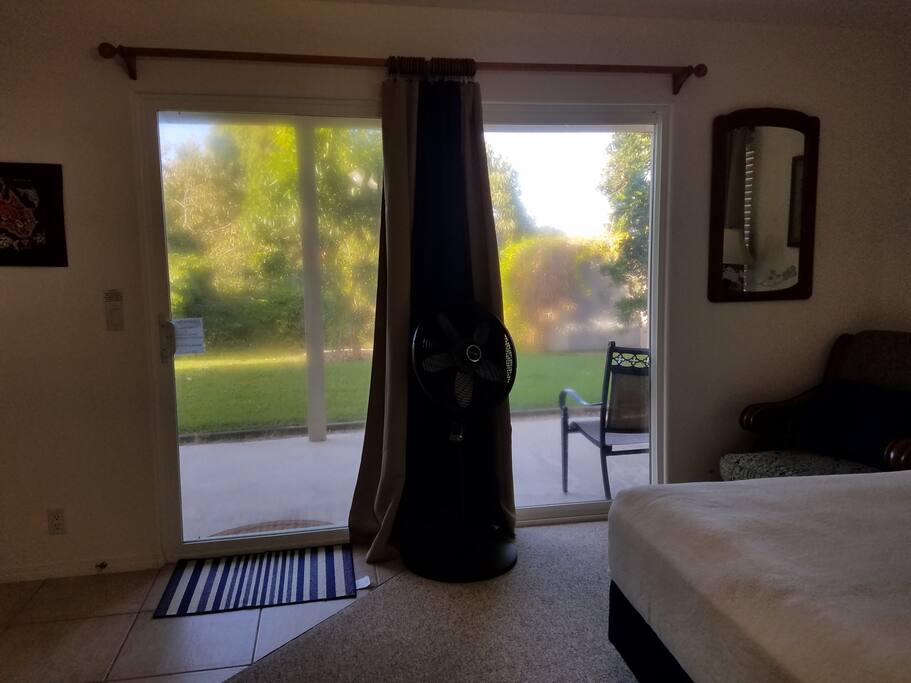 Slider window door entrance to room/exit to private lanai area with full length, light dark out drapes