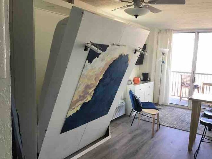 The Murphy bed is behind the painting.