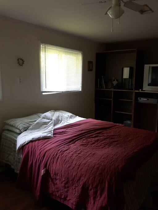 Queen size bed. Tv and fridge.