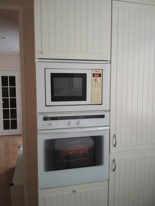 Kitchen. Built-in kitchen appliances: electric oven, microwave oven & fridge - all is Bosch
