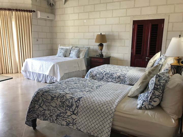 Large bedroom with Queen bed and two single beds - great for children or friends