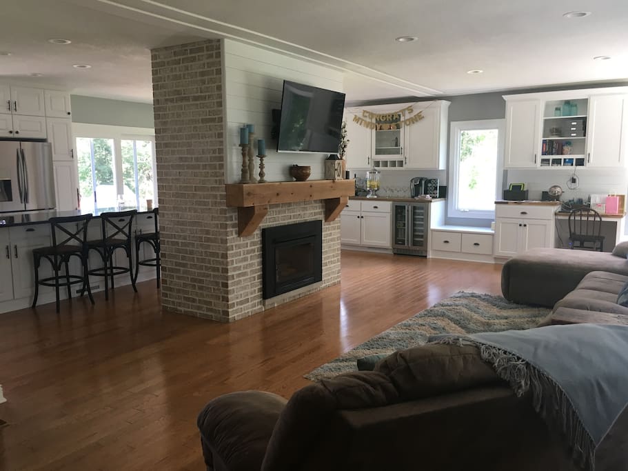 living room and fireplace into kitchen
