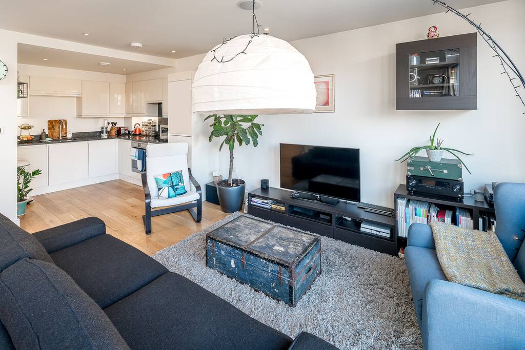 Spacious light living area with sofa bed