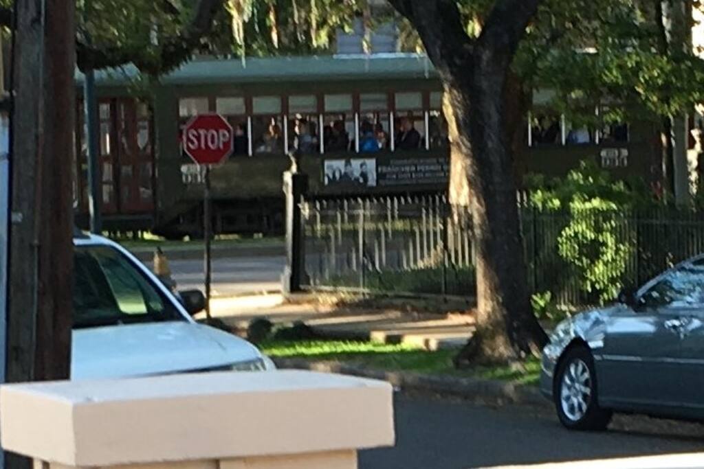 You can hear and see the St Charles Avenue streetcar rolling down the tracks from the front porch of this rental.