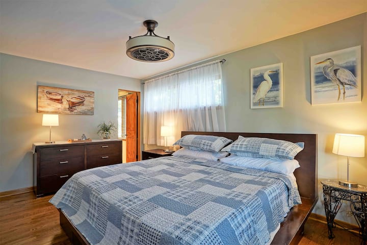 The Crane Room. Master Bedroom with lake view. Features king size bed and 50”smart tv with cable. Ceiling fan with remote.