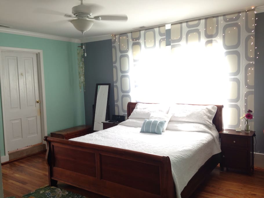 Master bedroom with king bed, also has a flatscreen TV, streaming services, and DVD player.