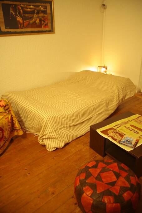 couch in living room made into bed