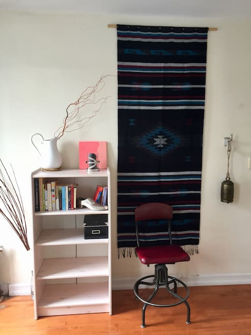 Reading nook: Bookshelf, art, vintage cushioned drafting chair