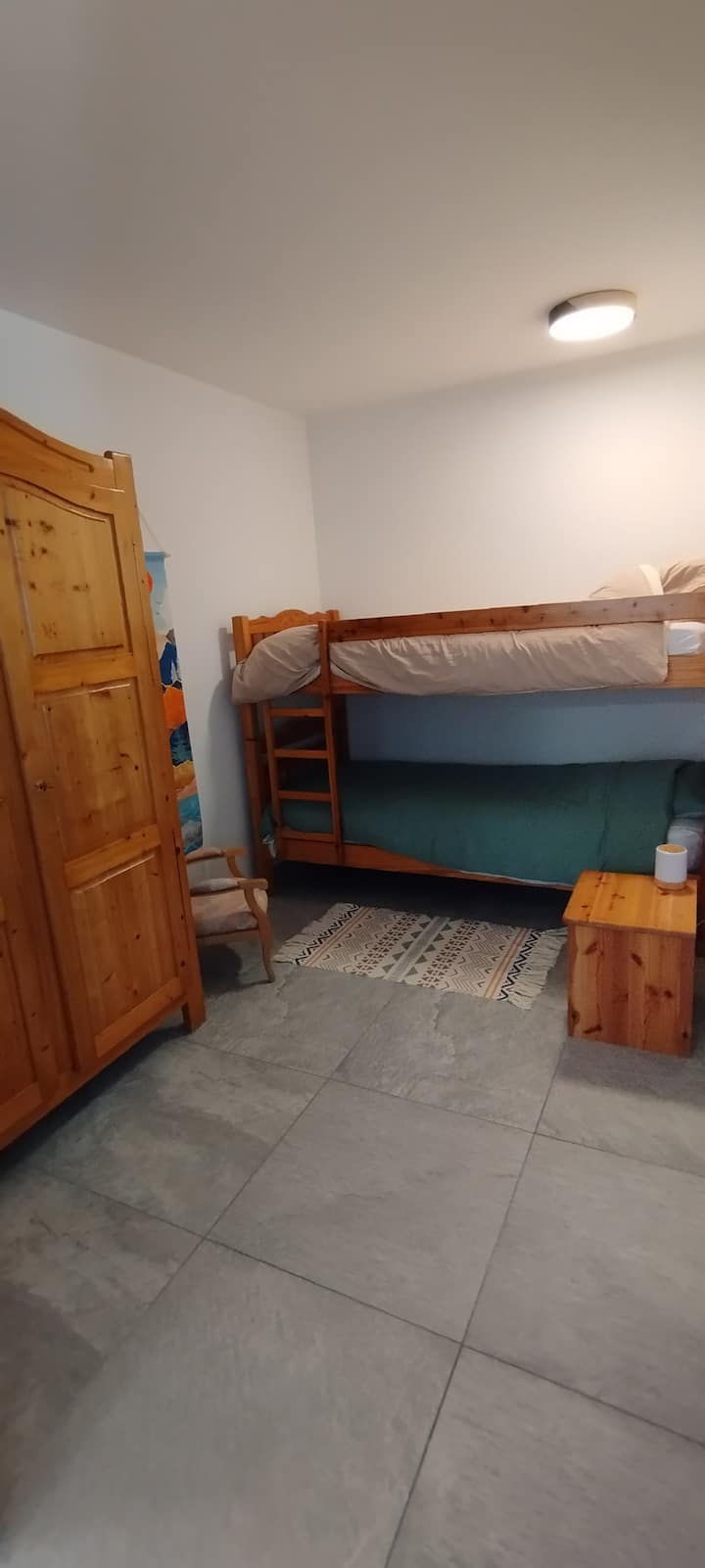 ركن جبلي مع أسرّة بطابقين وخزانة ملابس، مغلقة بستائر تعتيم