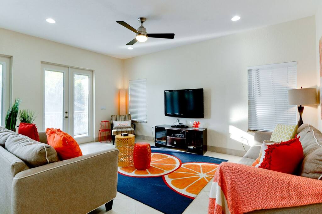 Comfortable living room with 2 queen sleeper sofas and large double doors to the balcony in the back yard.