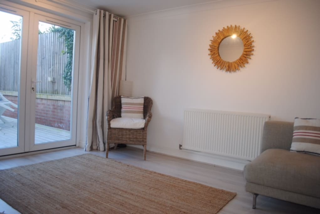 Bright sunny spacious living room. With patio doors to lovely private garden.
